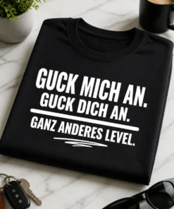 Minimalistisches T-Shirt mit dem Spruch „GUCK MICH AN. GUCK DICH AN. GANZ ANDERES LEVEL.“ in weißer Typografie